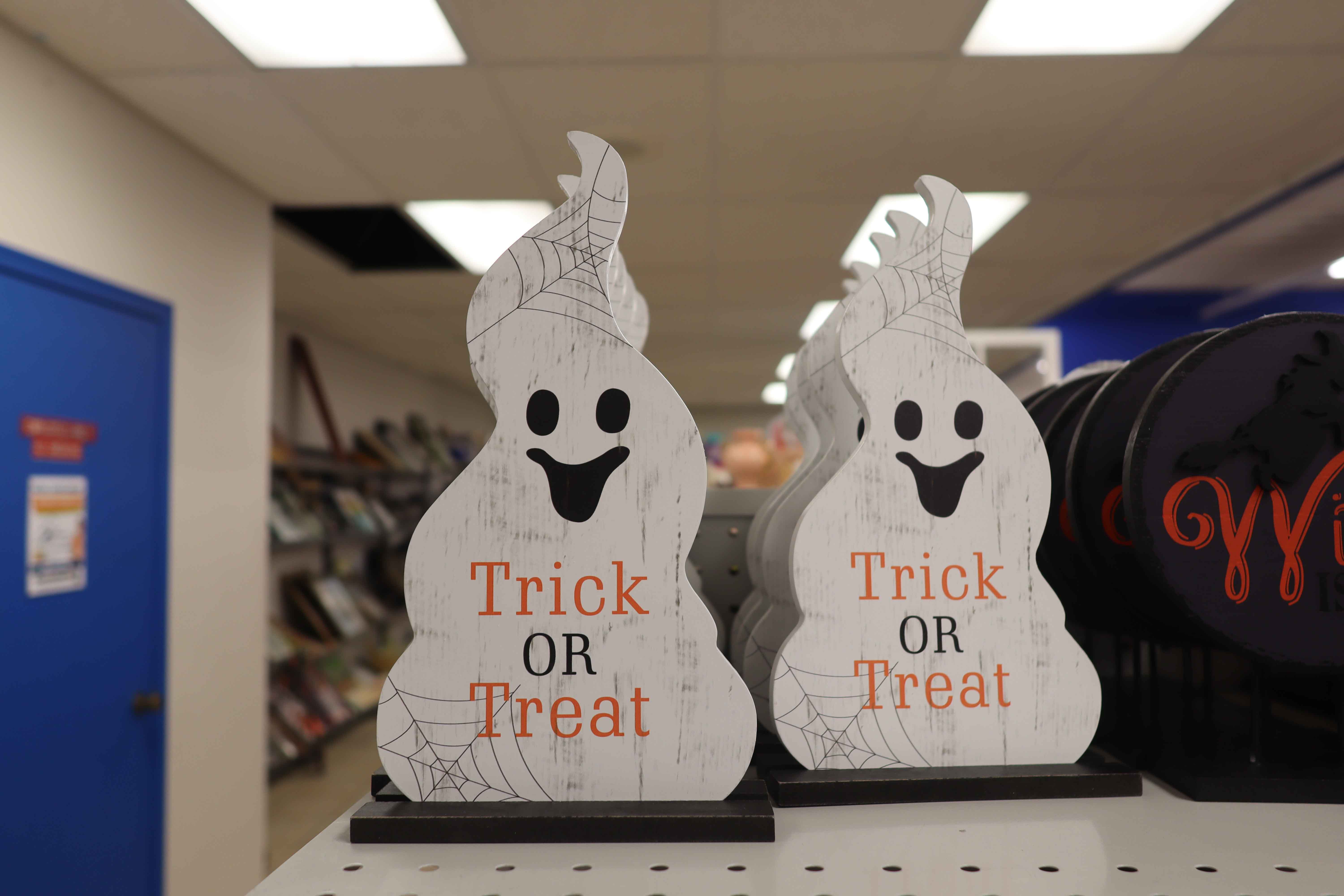 Ghost decorations stating "Trick or Treat".